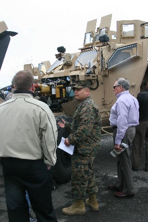 Chief Warrant Officer Benino Guerrero, USMC, a motor transport officer for the 1st Marine Expeditionary Force, discusses some of the features of the mine resistant ambush protected (MRAP) all terrain vehicle (M-ATV) at the January meeting.